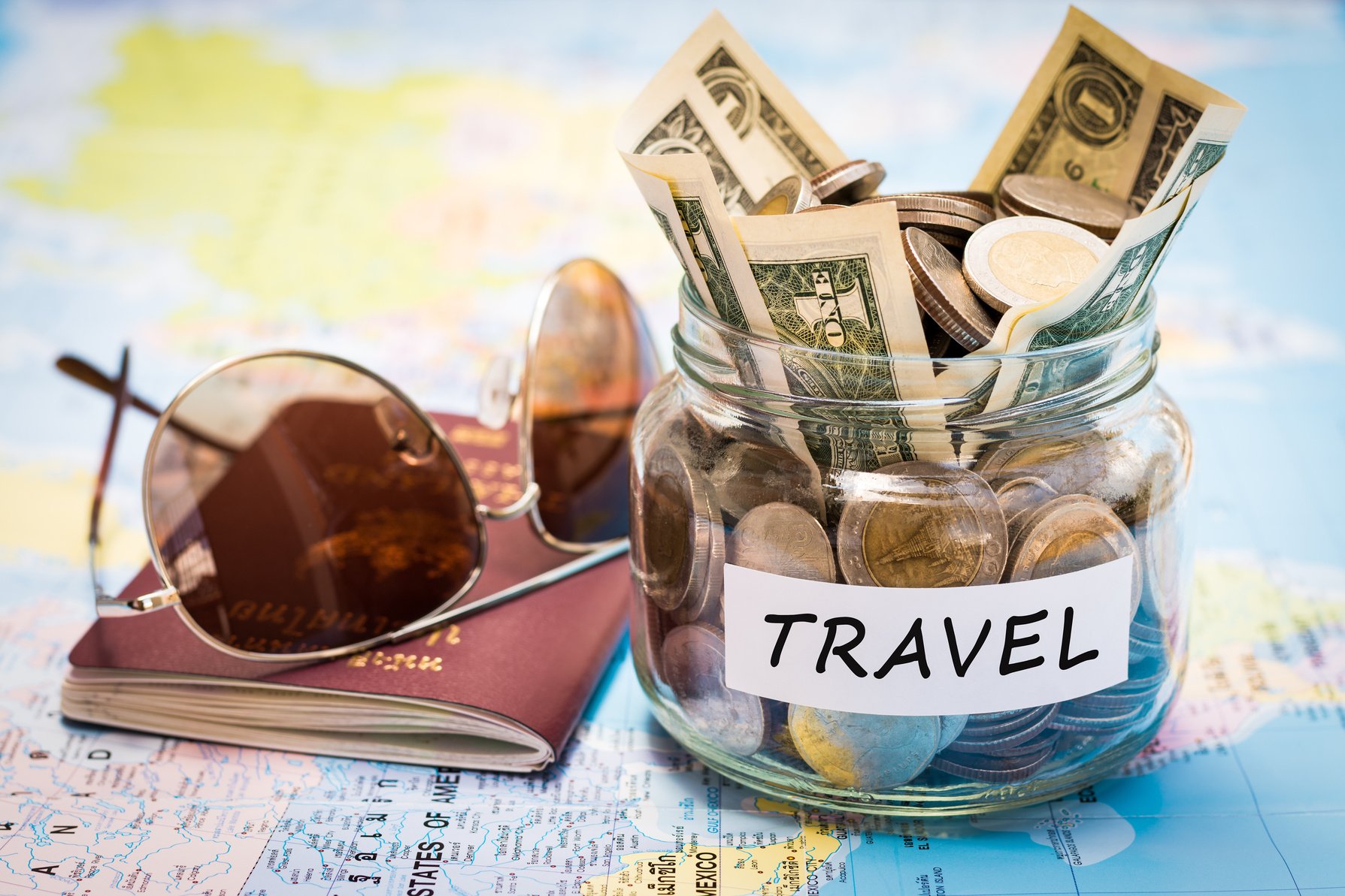 Travel budget concept with passport and sunglasses